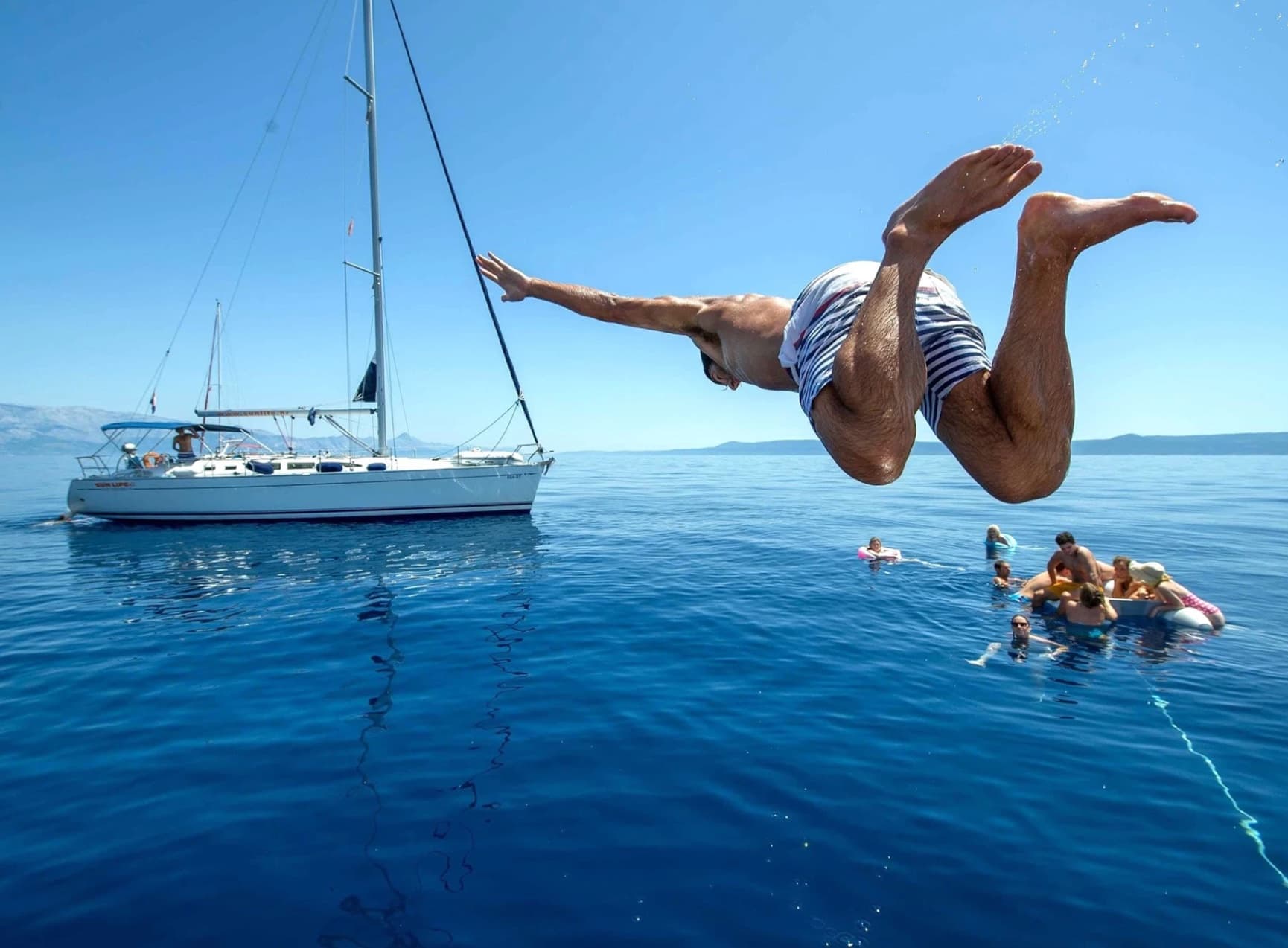 Backflip into the sea near a yacht